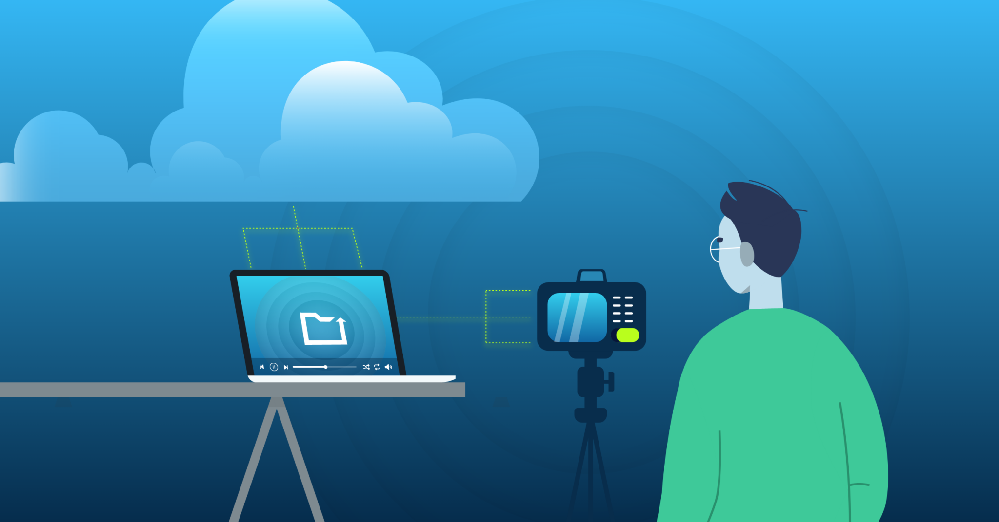 man using a camera on a tripod connected to a laptop